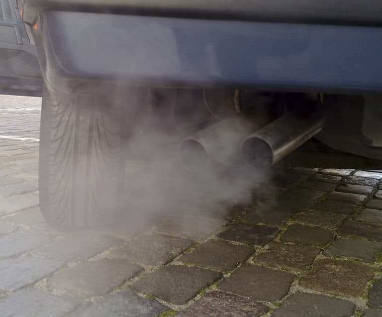 light grey smoke emanating from automobile exhaust