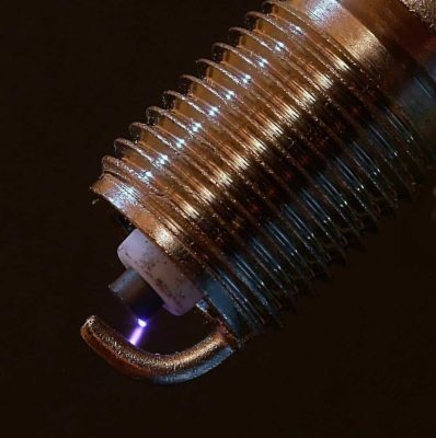 image of active spark plug with violet plasma between electrodes